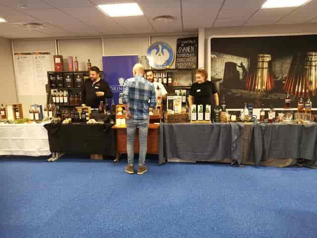 Ottersen branded exhibition booth at a corporate trade show with beverage sampling.