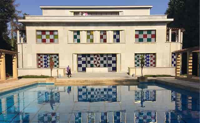 Villa Empain gala venue with symmetrical waterfront facade for luxury corporate events.
