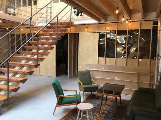 Industrial-chic coworking space in Palazzo with modern staircase for creative networking events.