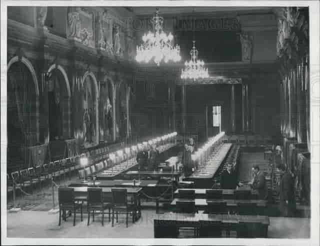 Formal long-table banquet setup in Palais des Académies conference center for corporate events.