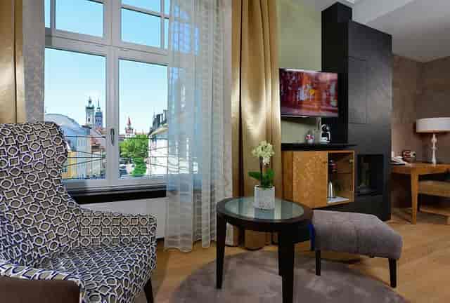 Hotel Torbräu premium room with workspace and city view for VIP travel or executive meetings.