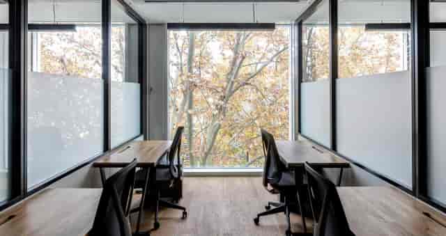 Minimalist office breakout space for one-on-one strategy sessions and intimate business meetings.