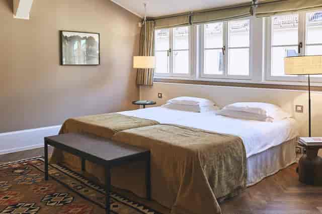 Twin-share hotel suite at Cortiina Hotel for corporate travel and conference accommodation.