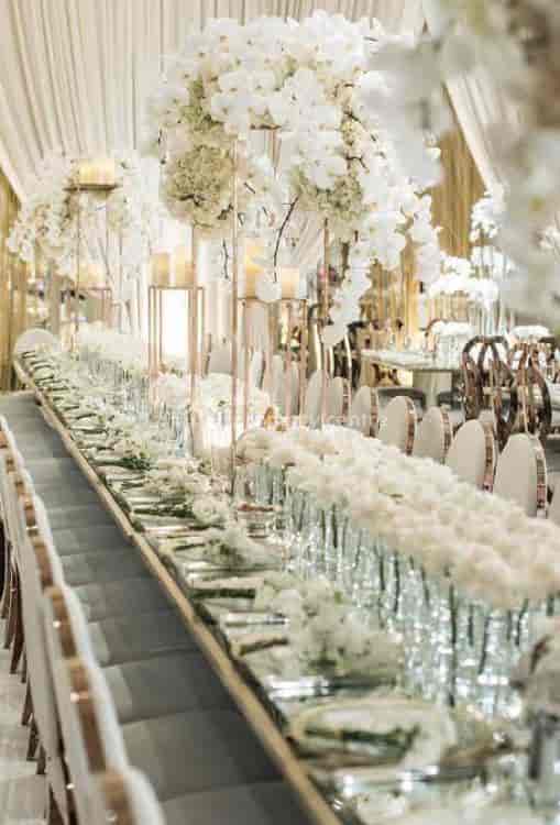 Luxury event hall tablescape with minimalist floral decor for upscale gala or wedding reception.