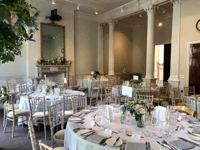 Elegant event space with round tables, perfect for weddings and corporate functions.