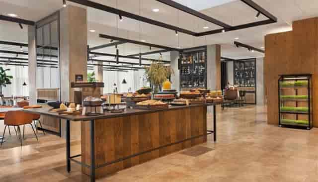 Corporate networking area with wood accents at Comwell Copenhagen Portside event venue.
