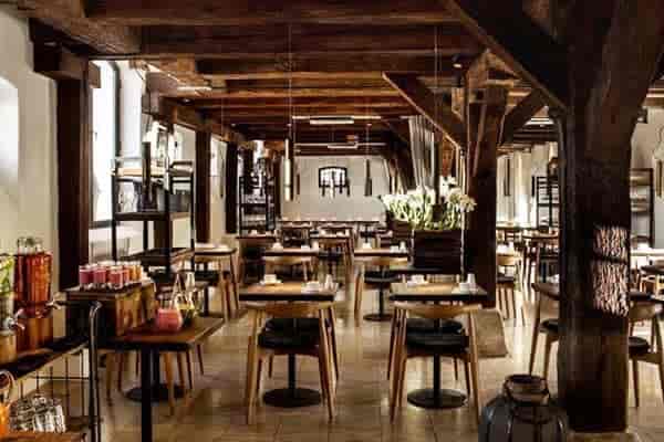 Rustic-industrial bar at 71 Nyhavn Hotel featuring timber beams for intimate event coffee breaks.