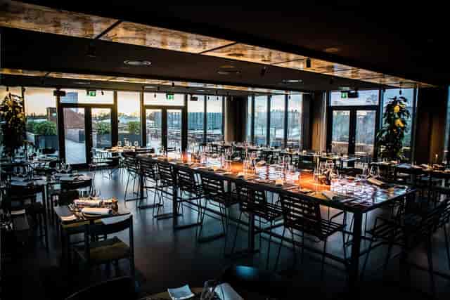 Upscale Hotel Ottilia bar with floor-to-ceiling windows, ideal for corporate dinners and receptions.