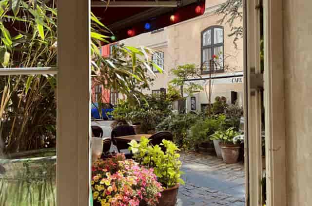 Courtyard terrace with bistro seating for networking events and boutique meetings.