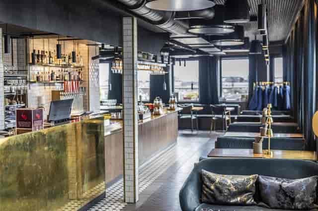 Brass-accented hotel bar for corporate networking and high-end evening mixers.