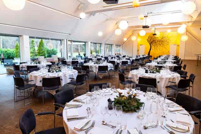 Rungstedgaard banquet hall with branded wall for formal dinner events and corporate meetings.