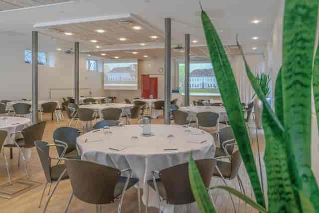 Kavalersalen conference room with cabaret seating, ideal for corporate meetings and presentations.