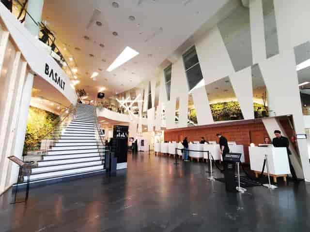 Modern hotel lobby with architectural staircase for corporate event registration and check-in.