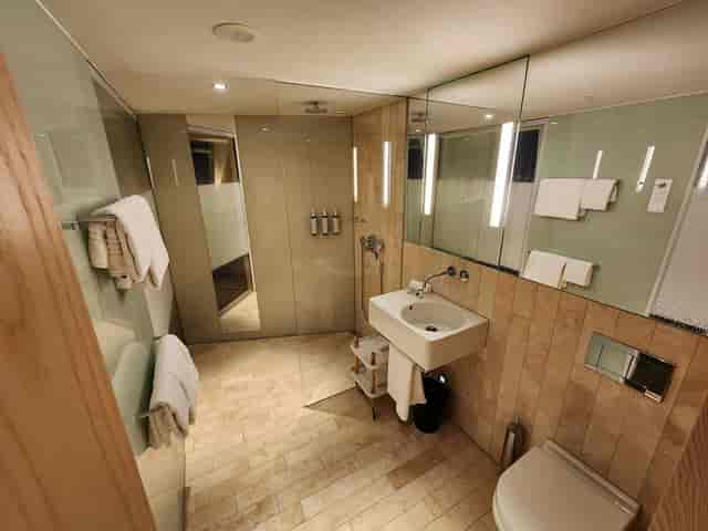 Modern Matterhorn hotel bathroom, spa-like design, corporate accommodation, luxury business travel.