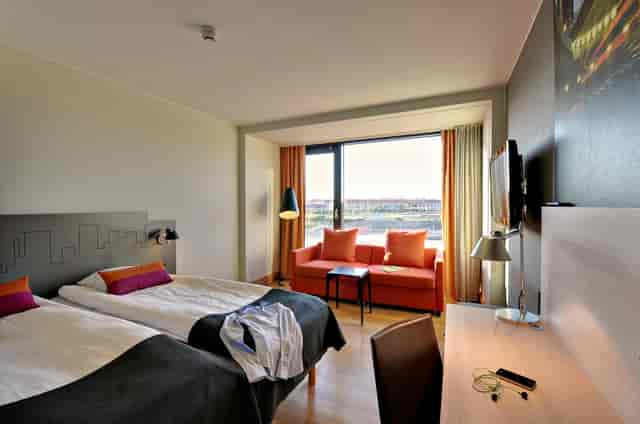 Scandic Sydhavnen guest room with workspace, ideal for corporate conference lodging.