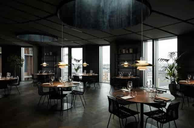 Moody minimalist restaurant space for exclusive boardroom dinners and networking events.