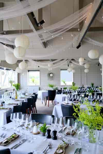 Budget-friendly Evarto restaurant venue with ceiling draping, lanterns, and minimalist decor.