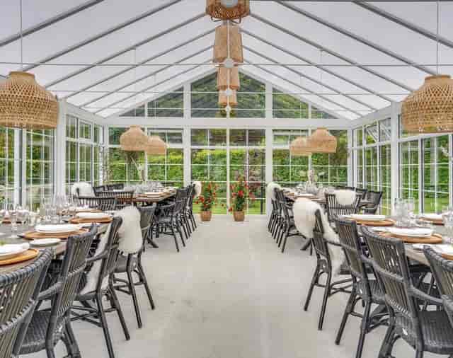 Glass-enclosed Evarto restaurant with rattan lighting for corporate luncheons and social events.
