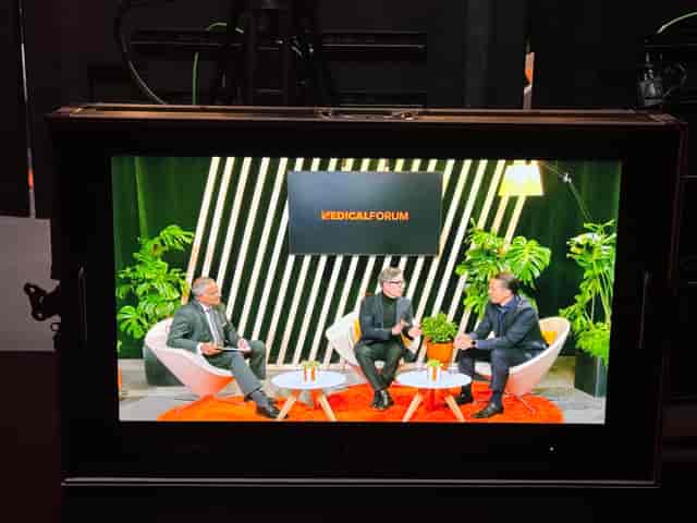 Virtual panel discussion setup with greenery backdrop for engaging events.
