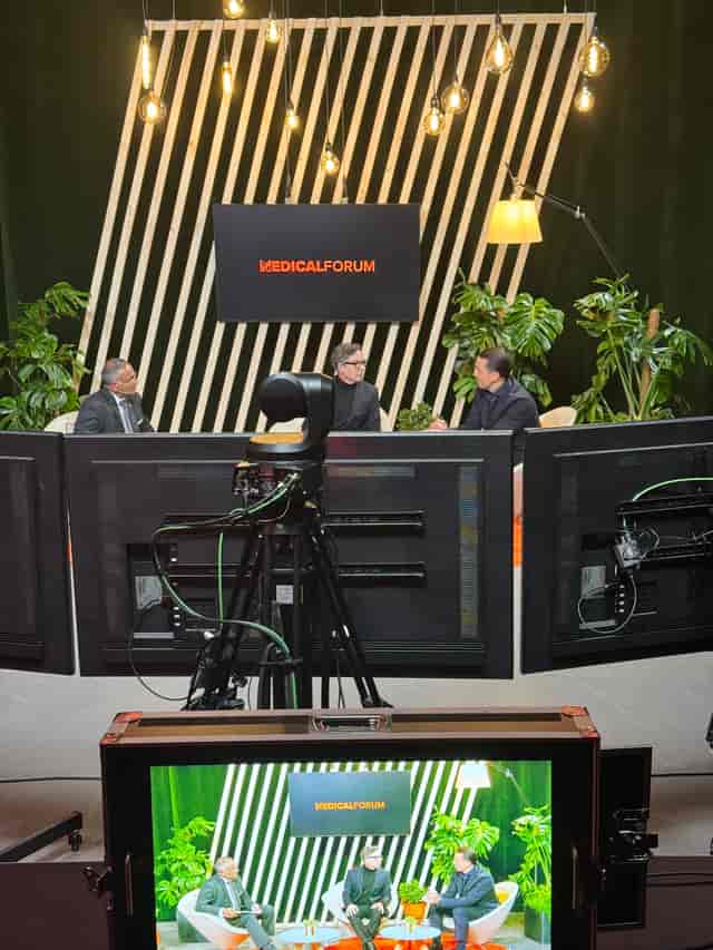 Dynamic panel discussion setup in LiveFRAME studio for engaging medical events.