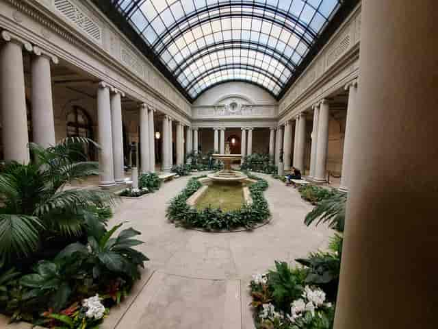 Elegant Frick Collection reception hall with central fountain for cocktail parties and product launches.