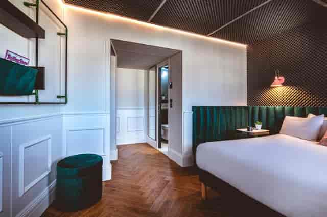 Modern ReMIX Hotel coworking room with herringbone floors for boutique event and VIP lodging.