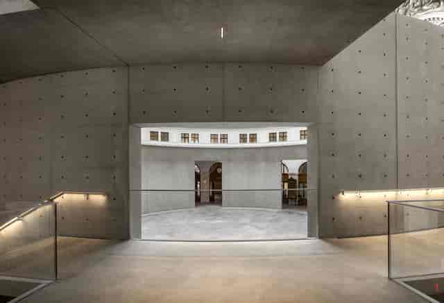 Bourse de Commerce minimalist auditorium for high-end product launches and networking events.
