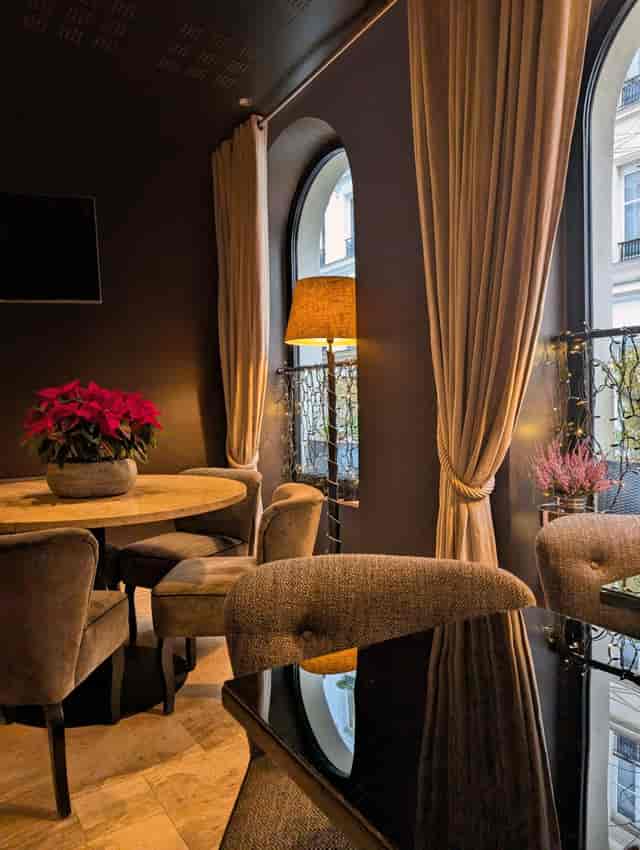 VIP consultation breakout space at B Montmartre Hotel featuring moody lighting and floral decor.
