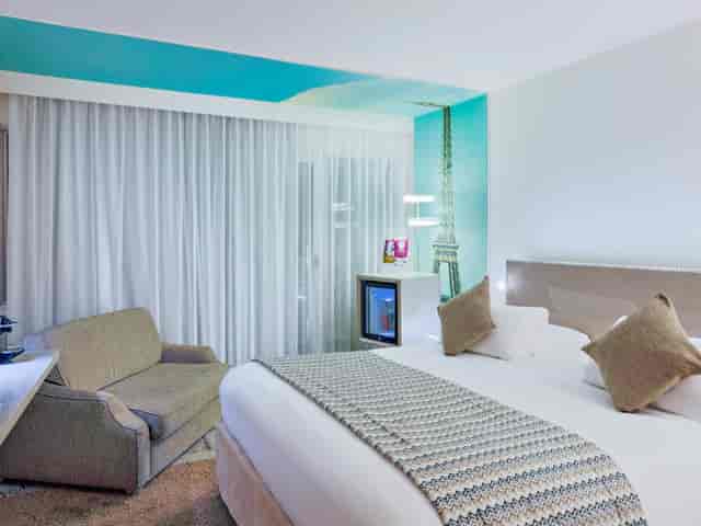 Modern hotel room at Mercure Paris Vaugirard with mural for conference and business travel lodging.