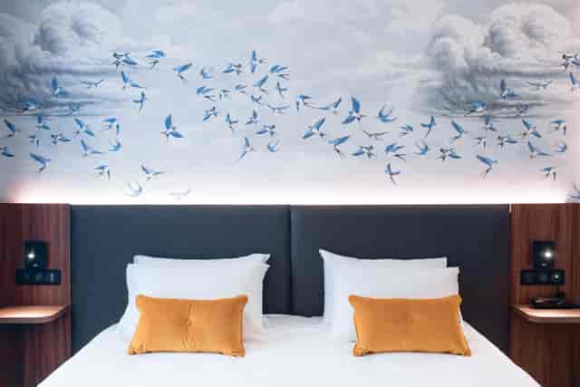 Le Salon Caché modern hotel room with integrated tech for corporate travel and business meetings.