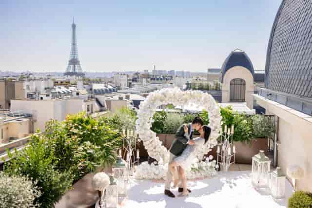 Paris rooftop micro-wedding setup with iconic Eiffel Tower backdrop for luxury event planning.