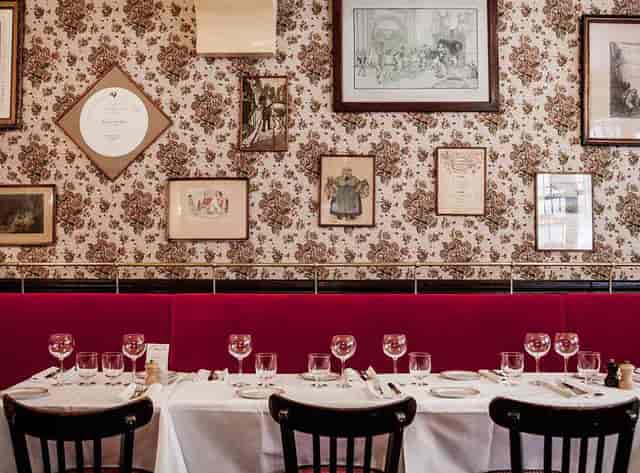 Benoit restaurant banquet seating, vintage gallery wall for private dining and corporate events.