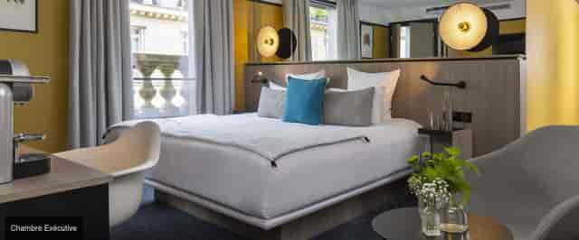 Modern Hotel Opéra Liège suite with workspace for business travel and executive conferences.