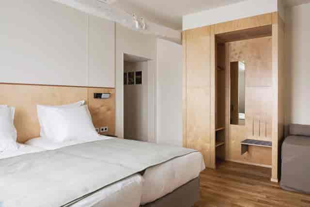 Modern hotel suite with minimalist design for business travel room blocks.