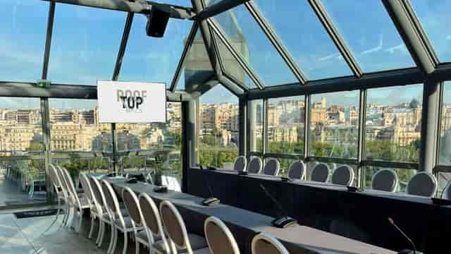 Boardroom set-up at Rooftop Grenelle conservatory with city views for corporate events and meetings.
