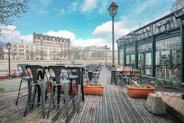 Open-air Grand Bleu riverside nightclub with industrial seating for Parisian corporate events.