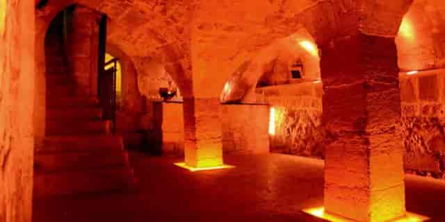 Cave voutée stone architecture, atmospheric venue for exclusive evening receptions and galas.
