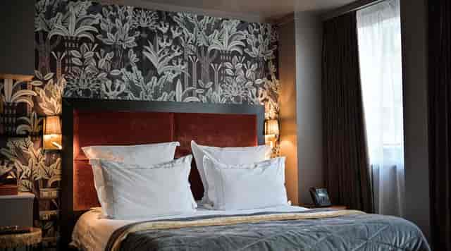 Boutique hotel room with accent wall for VIP event lodging and high-profile speaker accommodations.