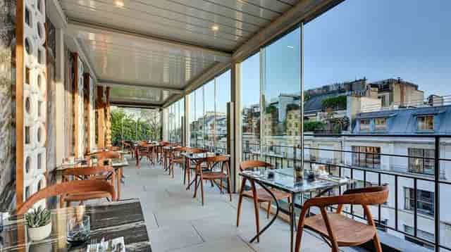 Retractable roof terrace bar at The One Alma Paris for luxury cocktail receptions and dinner events.