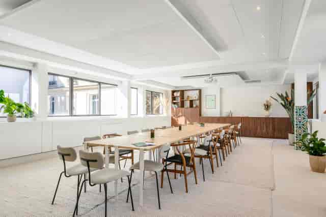 Minimalist boardroom with natural light for professional workshops and strategic planning meetings.