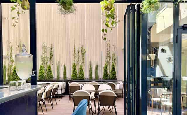 Restaurant Quantième terrace with vertical greenery for corporate networking and social events.