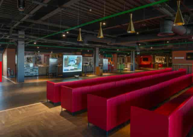 "Modern Carlsberg Dugout at Anfield Stadium with sleek red seating for conferences"