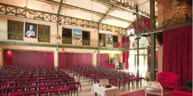 Industrial-chic theater setup at Abbaye de Collonges for corporate events and plenary sessions.