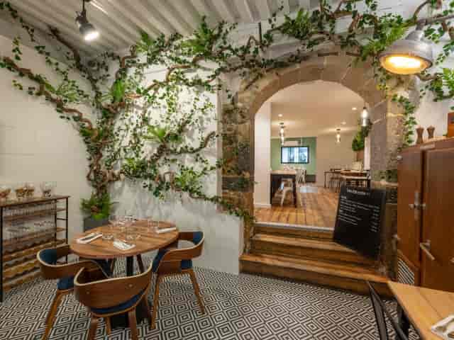 Rustic-chic VIP dinner space at Maison Moly with stone architecture for private events.