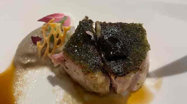 High-end plated entree at Maison Moly gala dinner, modern culinary presentation.