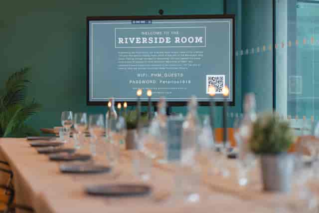 Riverside Room at People's History Museum with elegant table setup for corporate meetings.