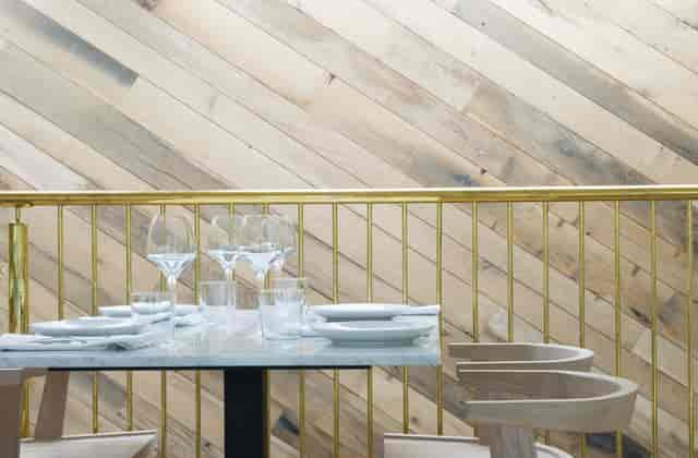 Modern dining room with marble tables for upscale corporate receptions and networking dinners.
