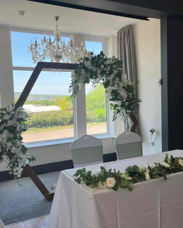 Geometric floral arbor for intimate wedding ceremony or sweetheart table at The Mill House.