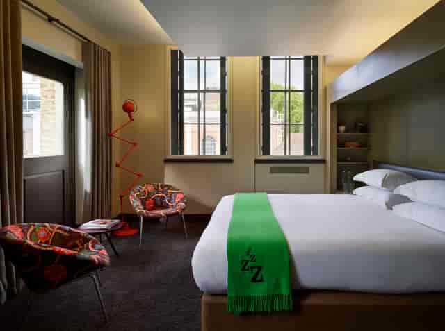 Modern hotel room at Marrable's Hotel, ideal for meetings and retreats with vibrant decor.