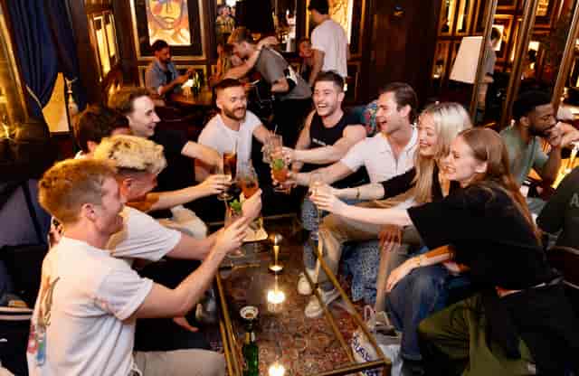 Lively social event at Backstage Soho with vibrant decor and engaged attendees.